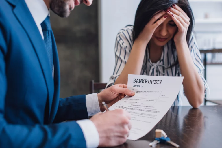 Woman expressing financial stress while speaking with an attorney in an office setting, illustrating wage garnishment concerns and legal options to stop wage garnishment in Denver.