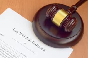 Judge’s gavel next to a “Last Will and Testament” document on a wooden surface, symbolizing estate planning, probate law, and the legal consequences of dying without a will in Denver.
