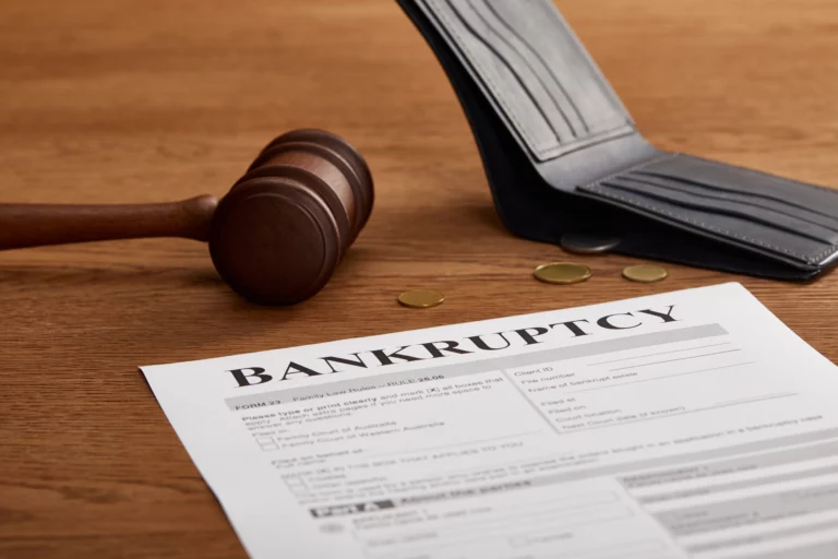 Bankruptcy exemption documents with a gavel, empty wallet, and coins representing asset protection under Colorado bankruptcy laws