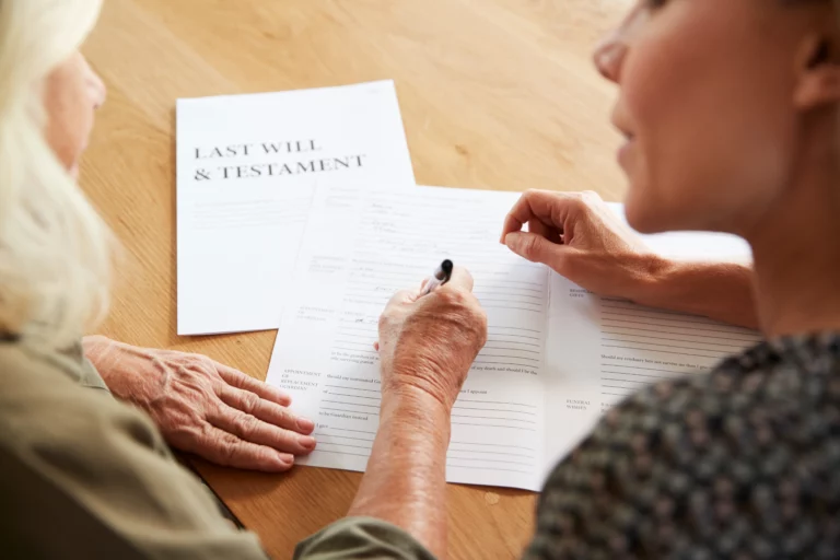 Older couple reviewing a last will and testament while comparing a living trust and will in Denver, Colorado